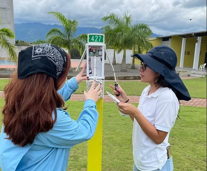 Technicians installing Veriground weather station 427